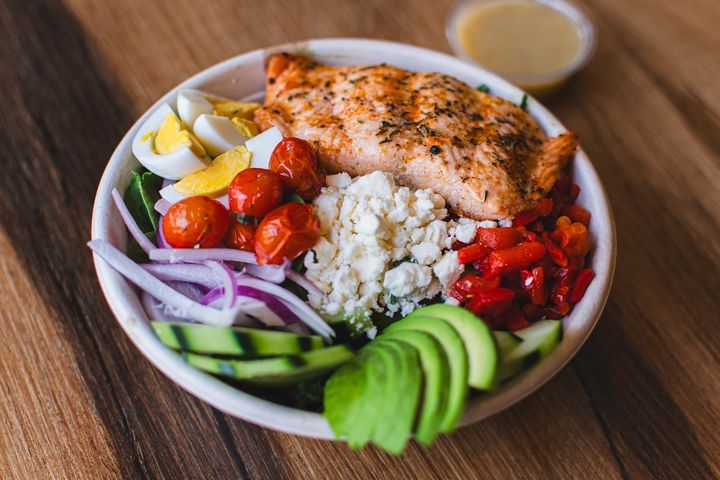 Power Protein Salmon Salad with salmon, kale, spinach, and citrus vinaigrette